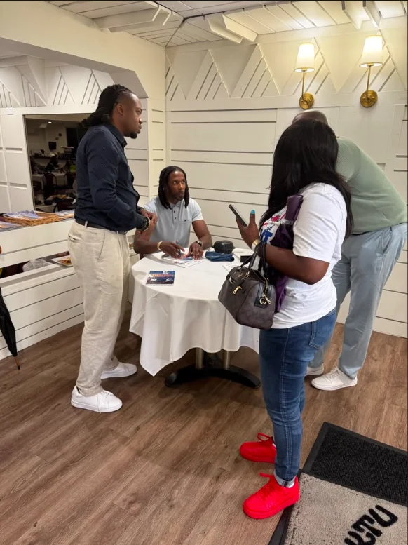 Marco Lomax meeting readers at an indoor book signing