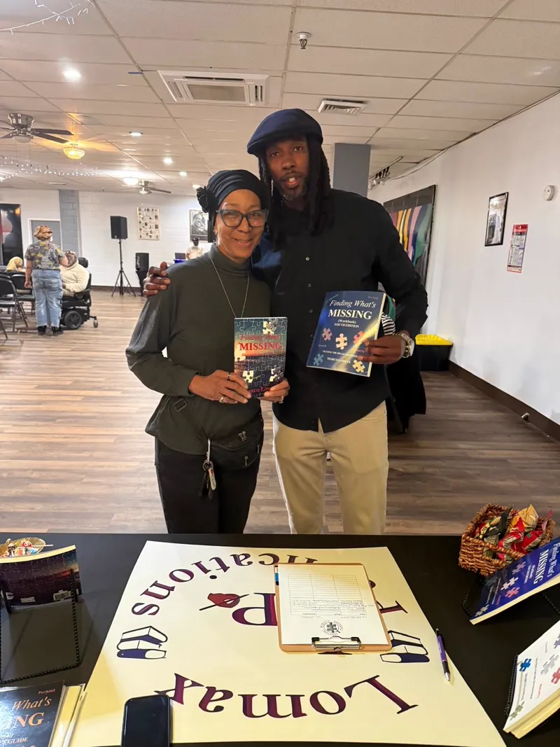 Marco Lomax with a reader at a community event